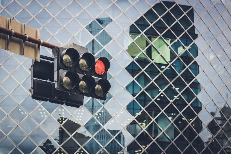 Full frame shot of glass building walls and traffic lights