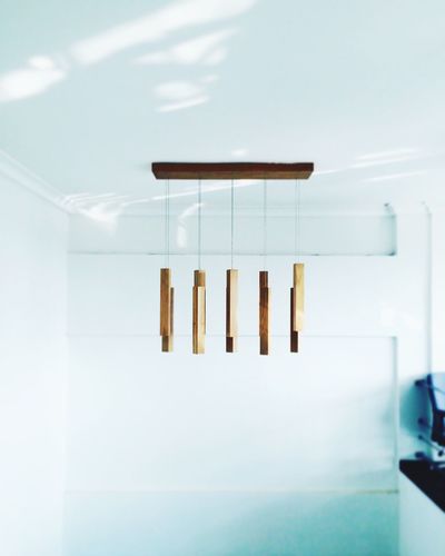 Wooden wind chime hanging on ceiling at home