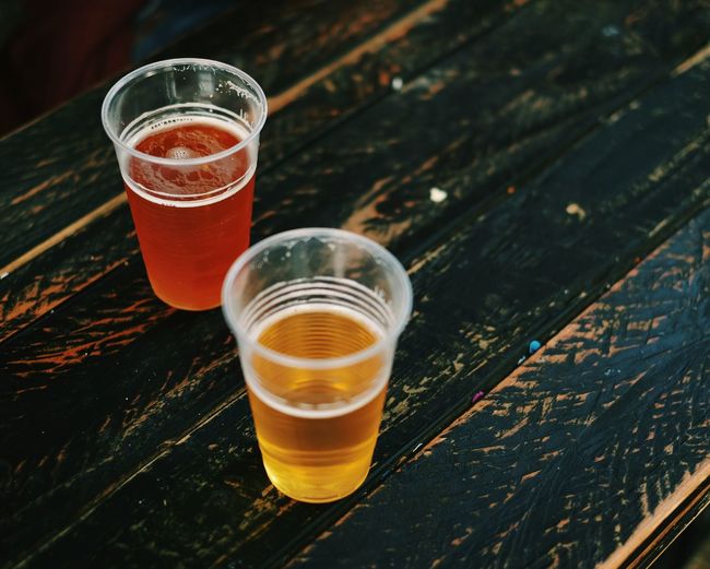 High angle view of beer in glasses on wooden table