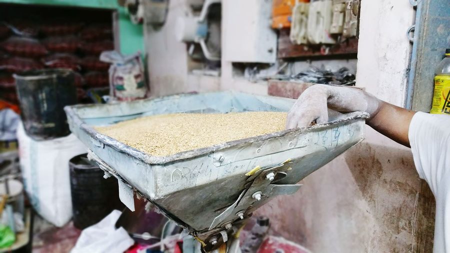 Close-up of person working at flour mill