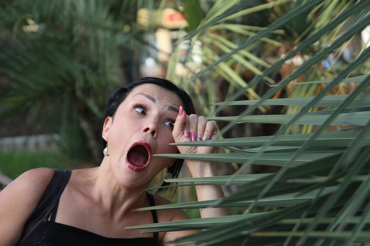 Close-up of woman shouting by plants