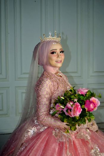 Portrait of bride holding flower bouquet