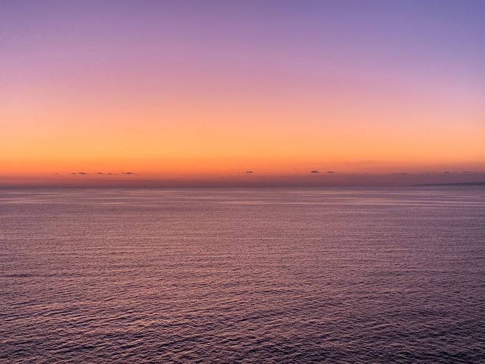 Scenic view of sea against romantic sky at sunset