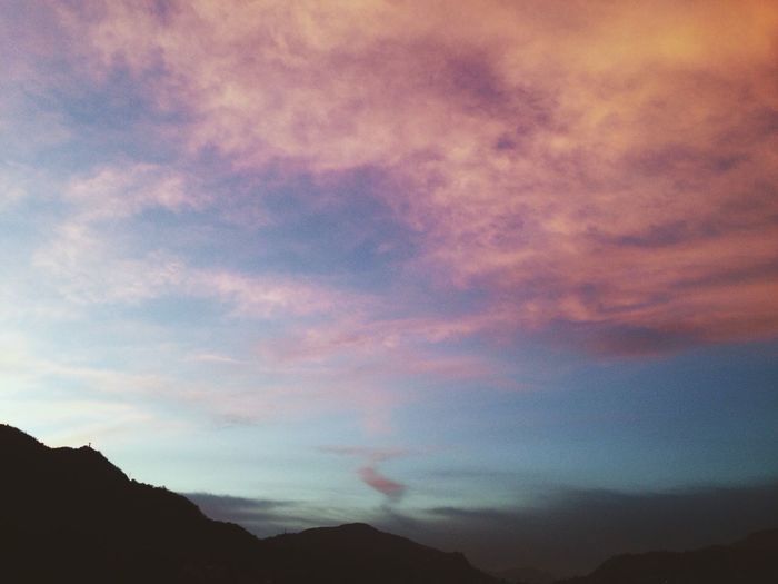Scenic view of mountains against cloudy sky