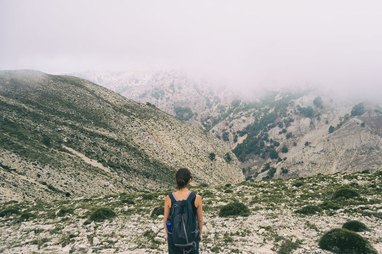 Woman hiking on a mountain path in catalonia on a cloudy summer day