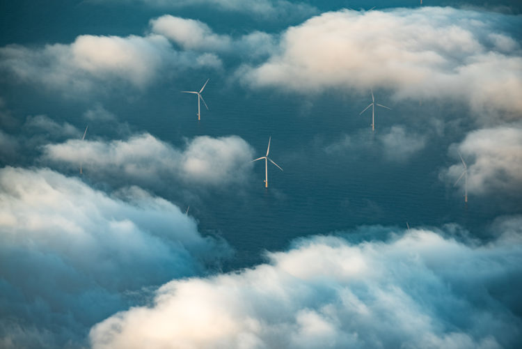 Wind turbines in sea with clouds
