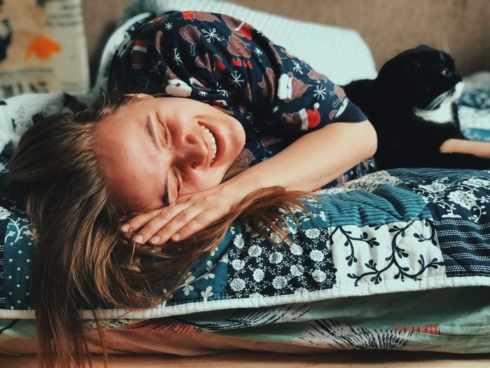 Portrait of smiling girl lying on bed