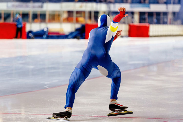 Full length of man ice skating on rink