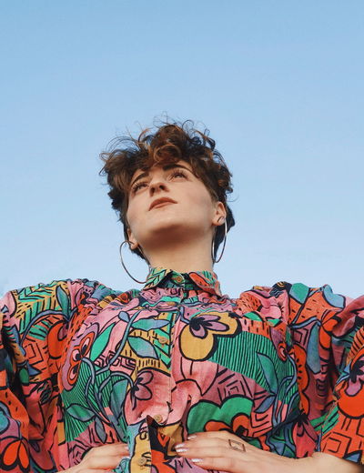 Low angle view of man standing against clear sky