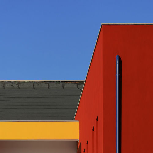 Low angle view of building against clear blue sky