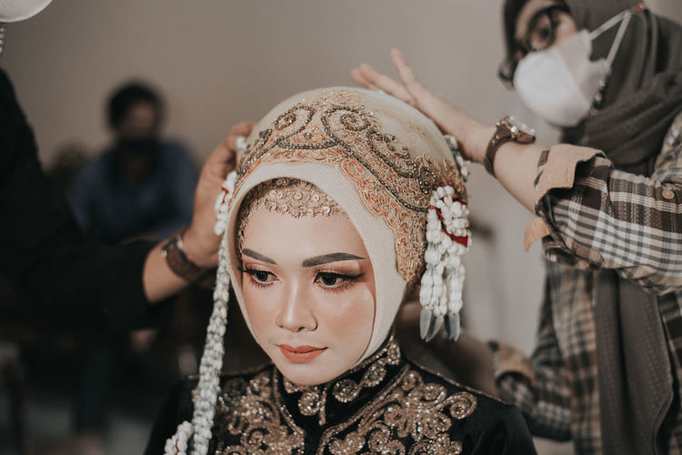 Portrait of a young woman processing wearing custom javanese traditional