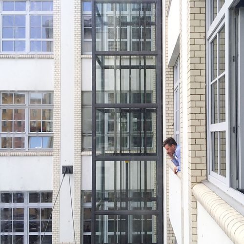 Man peeking through window from building