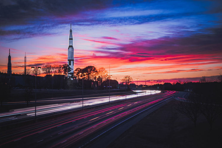 Space and rocket center in huntsville, alabama with sunset and car light trails. 