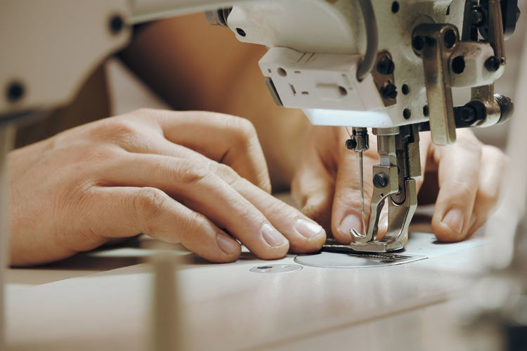 Cropped hands sewing machine part