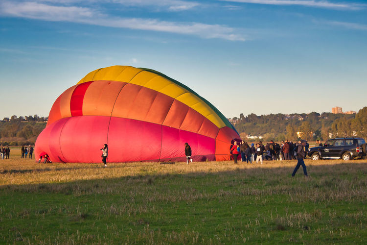 View of hot air balloons on field
