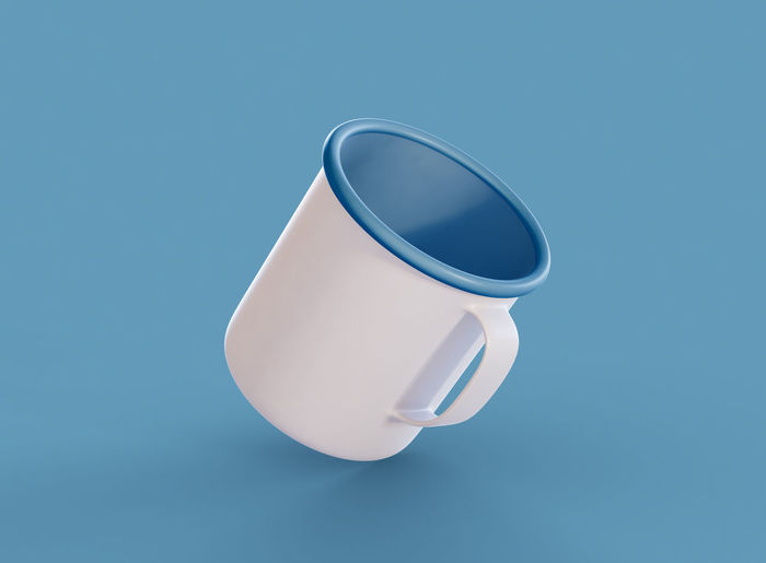 Close-up of coffee cup against blue background