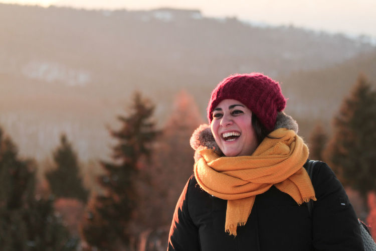 Portrait of smiling young woman during winter