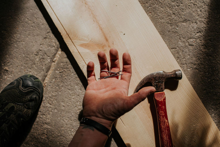 Overhead shot of man holding nails in his hand