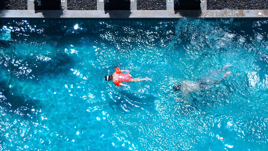 High angle view of people swimming in pool