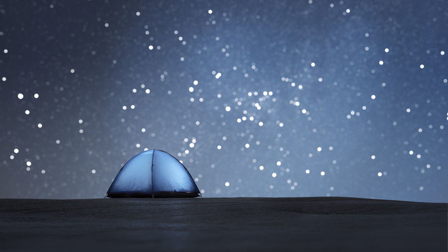 Luminous tent. starry bokeh in the background. with copyspace