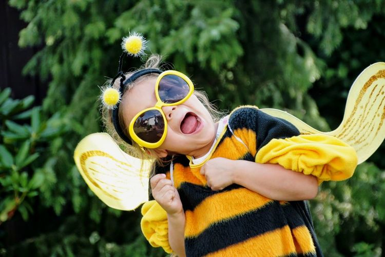 Close-up portrait of girl wearing bee costume