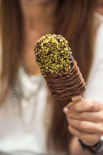 Close-up of woman holding chocolate ice cream