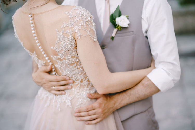 Midsection of couple holding hands