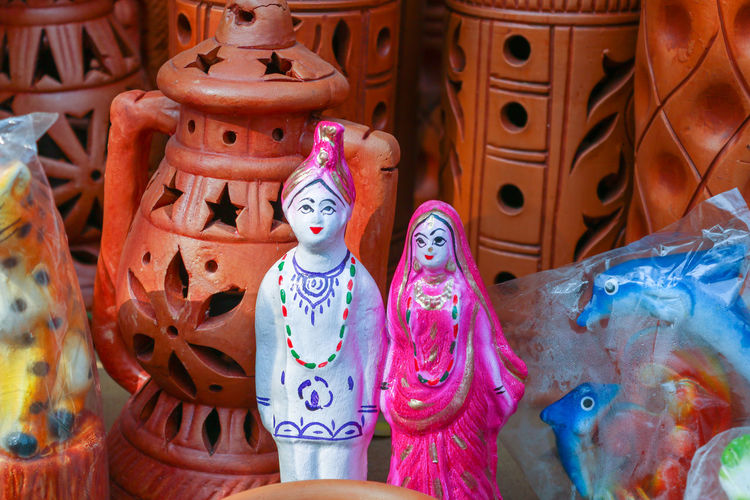 Close-up of bride and groom dolls for sale in market
