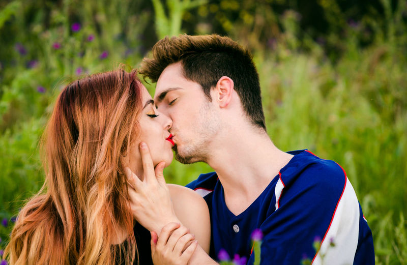 Close-up of couple kissing amidst plants