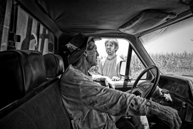 Young man talking with truck driver