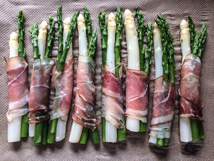 High angle view of asparagus rolled in bacon