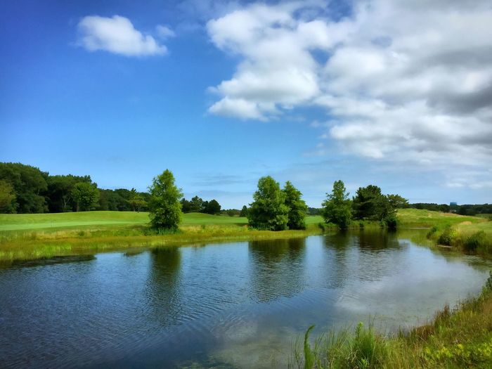 Scenic view of lake against cloudy sky