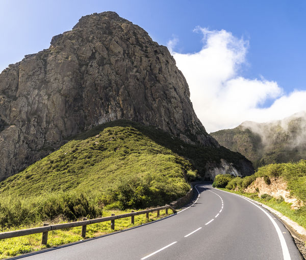 Road amidst mountains against sky