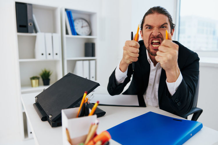 Portrait of angry businessman at office