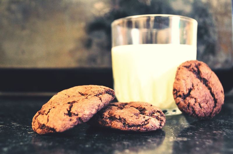 Close-up of cookies with milk on table