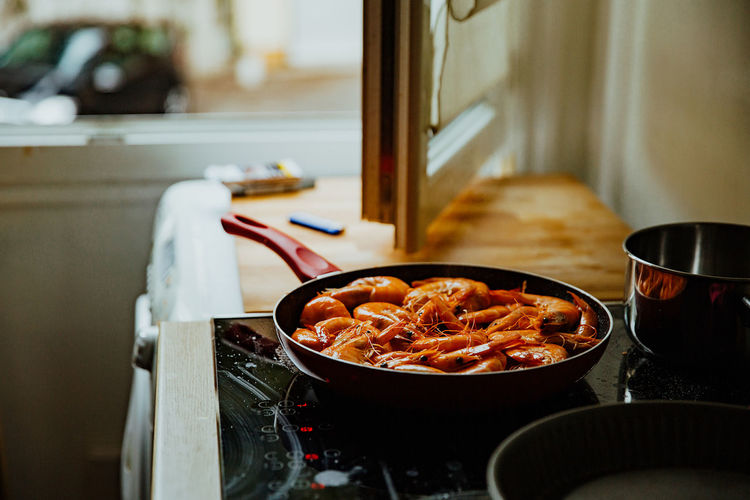 Close-up of shrimps in pan on stove at home