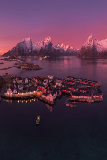 Aerial landscape of calm river and rocky formations located in hamnoy under sunset sky in evening