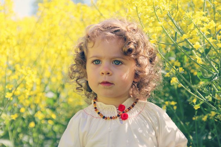 Portrait of cute girl with yellow flowers