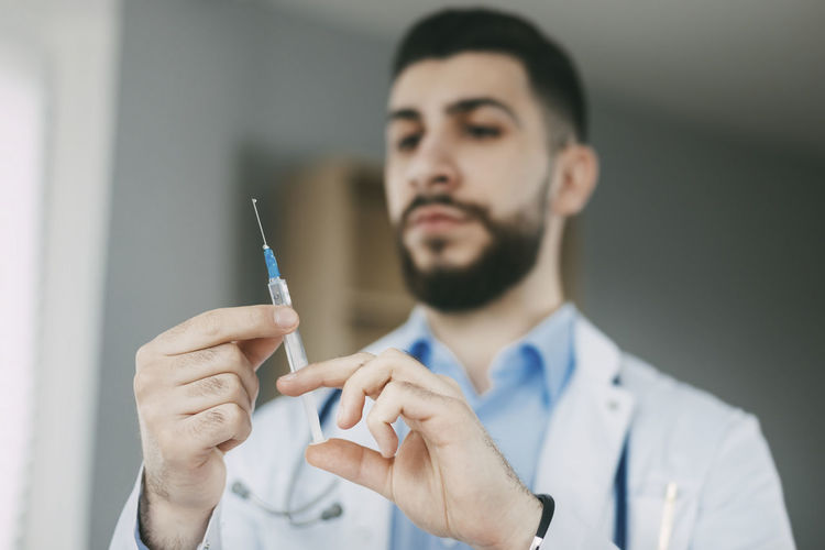 The doctor prepares for the injection with a syringe. medical concept, close-up