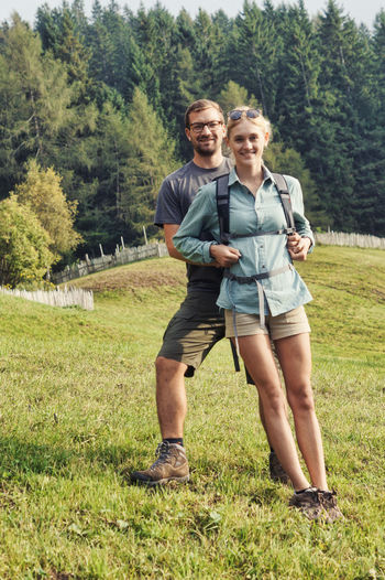 Full length portrait of couple standing on land