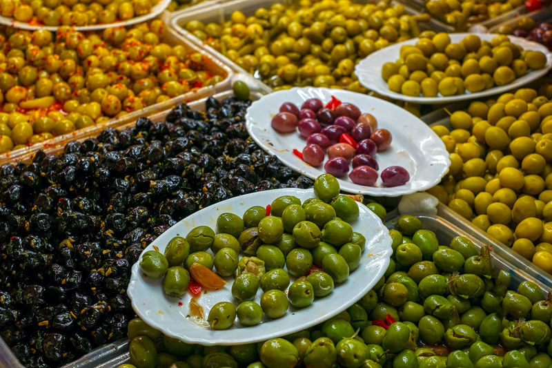 A variety of types of olives at a market stall