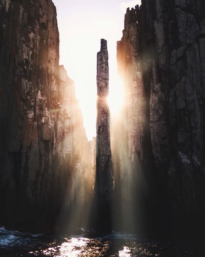 Sunlight streaming through rocks in water