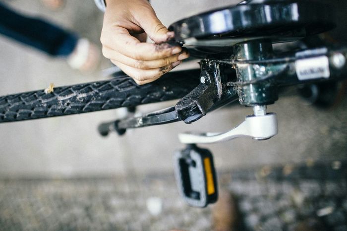 High angle view of person repairing bicycle