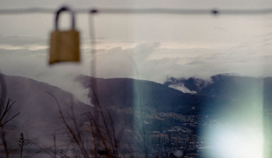 Digital composite image of mountain seen through glass window