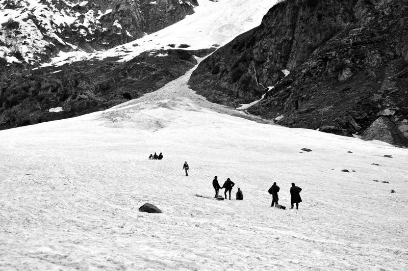 Tourists on snow covered mountain