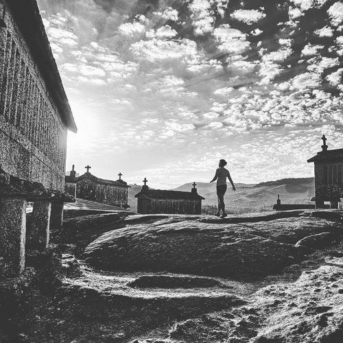 People standing by buildings against sky