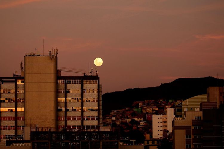 Buildings in city at sunset