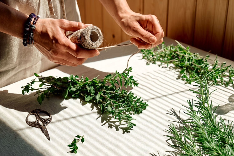 Alternative medicine. woman herbalist preparing fresh organic herbs for natural herbal treatments.