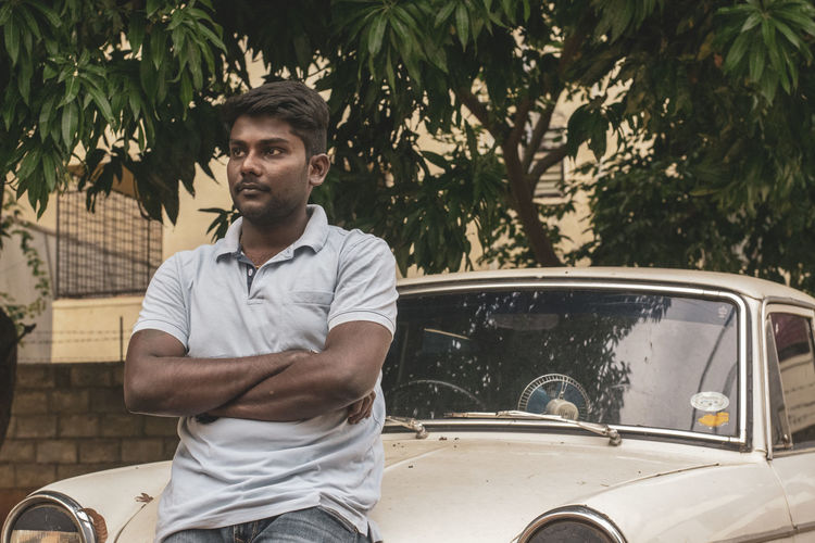Young black man looking away in car