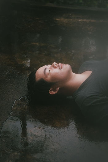 High angle view of woman lying in water